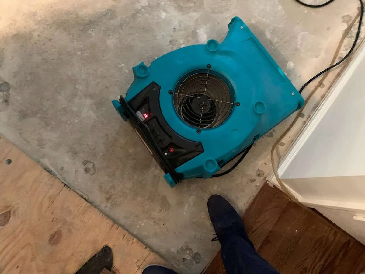 Air mover drying subfloor during Leak Detection & Repair in Richfield